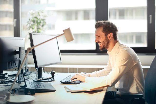 man-in-white-dress-shirt-sitting-on-black-rolling-chair